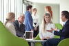 a group of people looking at a laptop